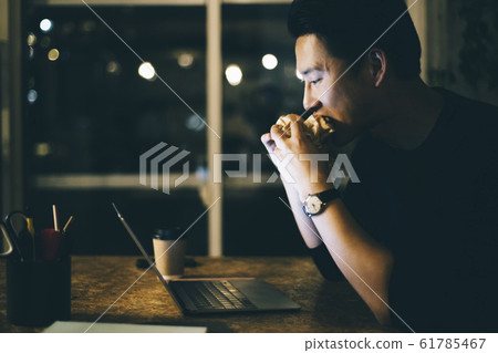 Men eating rice while working 61785467