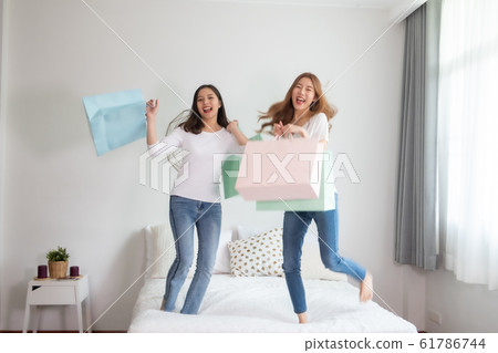 Cheerful happy Asian woman enjoying shopping Cheerful happy Asian woman enjoying shopping 61786744
