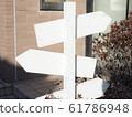 Signpost direction arrow signboard here and there 61786948