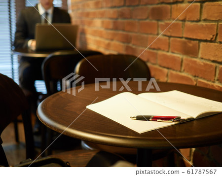 Man operating a computer: notebook at the table Man operating a computer: notebook at the table 61787567