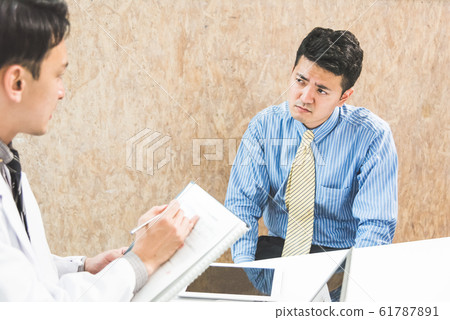 A man consulted by a doctor 61787891