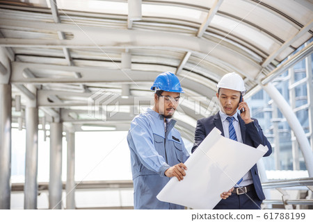 Construction engineer in Safety Suit Trust Team Holding White Yellow Safety hard hat Security Construction engineer in Safety Suit Trust Team Holding White Yellow Safety hard hat Security 61788199