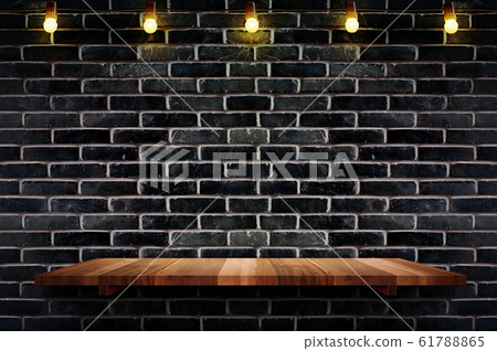 Empty brown plank wood shelf at black brick wall 61788865