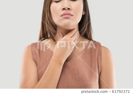 Female with suffering from acid reflux or heartburn 61792372