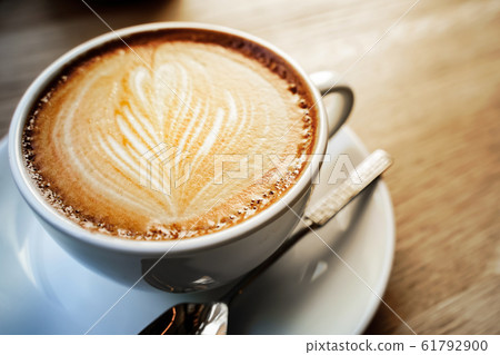 cup of the latte art coffee with warm light 61792900