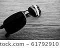 Single simple sun glasses on the wooden table with 61792910