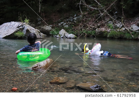 Children playing in the river Children playing in the river 61792958