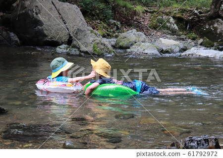 Children playing in the river Children playing in the river 61792972