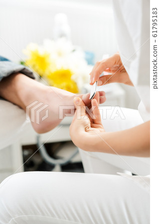 Podiatrist working on men's feet 61795183
