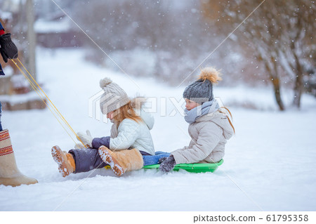 Family of dad and kids vacation on Christmas eve outdoors Family of dad and kids vacation on Christmas eve outdoors 61795358