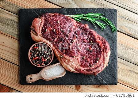Marbling ribeye steak on wooden board 61796661
