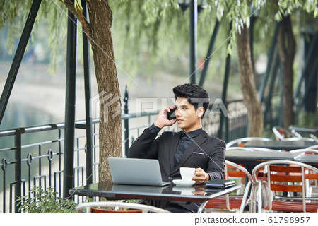 Businessman In Open-Air Cafe Businessman In Open-Air Cafe 61798957