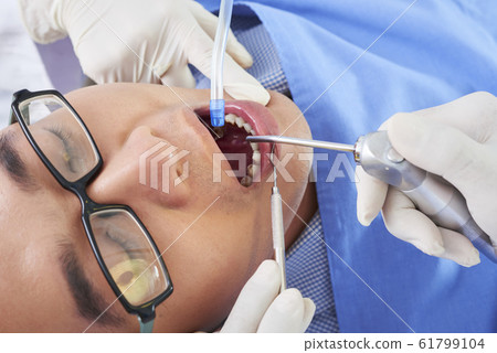 Asian Man On Dentist Chair 61799104