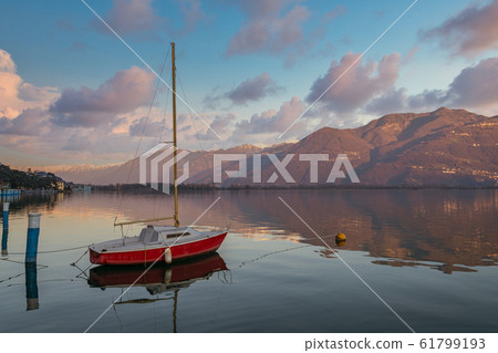 nice view of red boat on stunning mountain Iseo nice view of red boat on stunning mountain Iseo 61799193