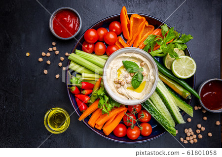 Hummus platter with assorted snacks. 61801058