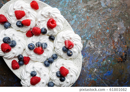 Meringues cakes with berries Meringues cakes with berries 61801082