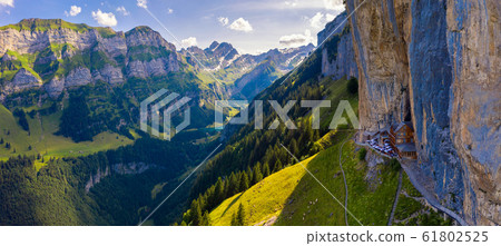 Swiss Alps and a restaurant under a cliff on mountain Ebenalp in Switzerland 61802525