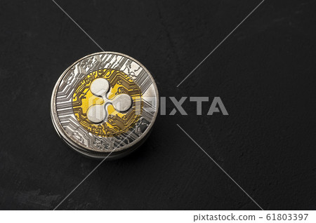 Bitcoin coins lies on a black background 61803397