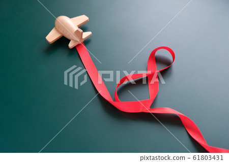 small wooden toy airplane carries a figure-shaped small wooden toy airplane carries a figure-shaped 61803431