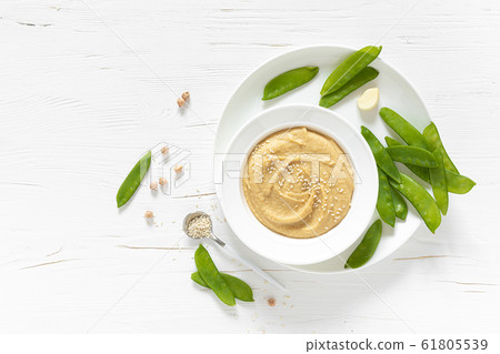 Homemade chickpea hummus served with green peas, Homemade chickpea hummus served with green peas, 61805539