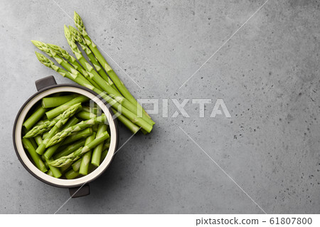 Fresh green asparagus on gray concrete background Fresh green asparagus on gray concrete background 61807800