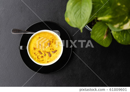 Serving of aromatic turmeric black coffee against Serving of aromatic turmeric black coffee against 61809601