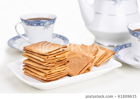 Kueh kapit with peanut and butter, with coffee Kueh kapit with peanut and butter, with coffee 61809635