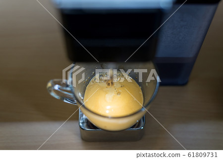 espresso machine with hot coffee in glass for refreshment 61809731