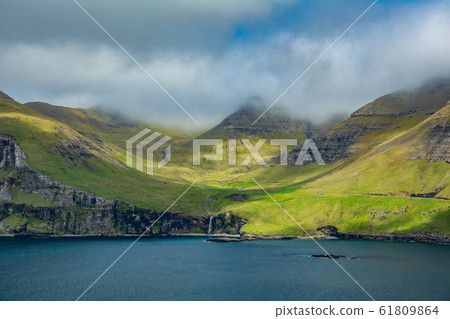 Typical Faroe islands coastline with waterfall 61809864