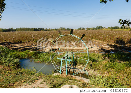 Water turbine on a cotton field. 61810572