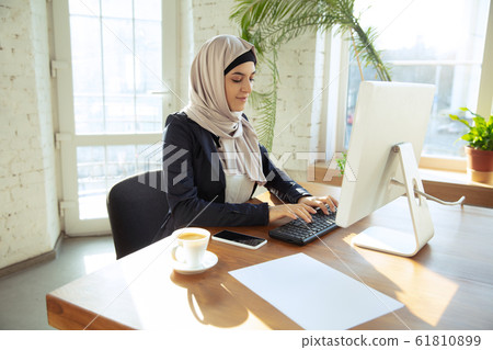 Portrait of a beautiful arabian businesswoman wearing hijab while working 61810899