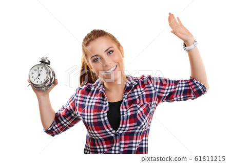 Smiling young girl holding an alarm clock with 61811215