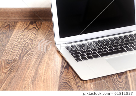 Laptop computer on wooden background Laptop computer on wooden background 61811857