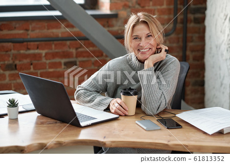 Excited business lady in office Excited business lady in office 61813352