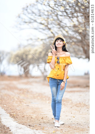Young woman walking casually Young woman walking casually 61814633