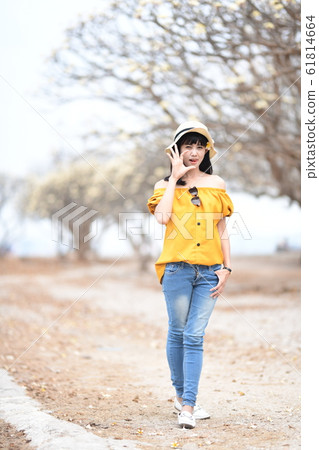 Young woman walking casually Young woman walking casually 61814664
