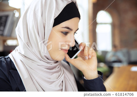 Portrait of a beautiful arabian businesswoman wearing hijab while working Portrait of a beautiful arabian businesswoman wearing hijab while working 61814706