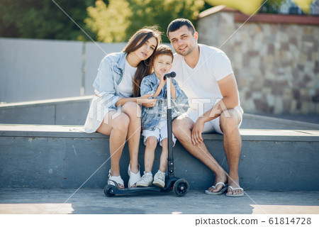 Cute family playing in a summer park Cute family playing in a summer park 61814728