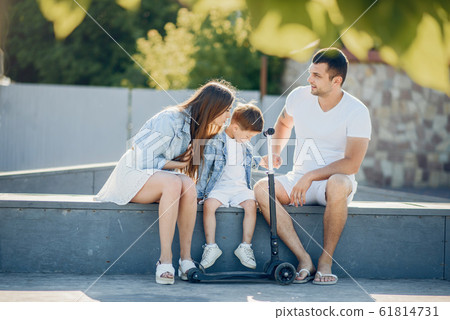 Cute family playing in a summer park 61814731