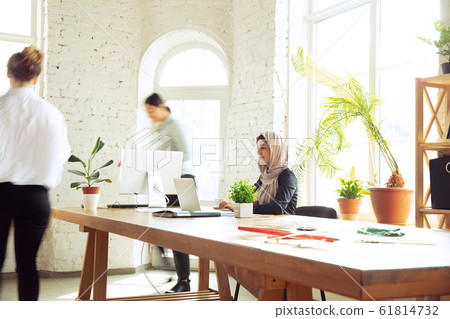 Portrait of a beautiful arabian businesswoman wearing hijab while working Portrait of a beautiful arabian businesswoman wearing hijab while working 61814732