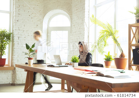 Portrait of a beautiful arabian businesswoman wearing hijab while working Portrait of a beautiful arabian businesswoman wearing hijab while working 61814734