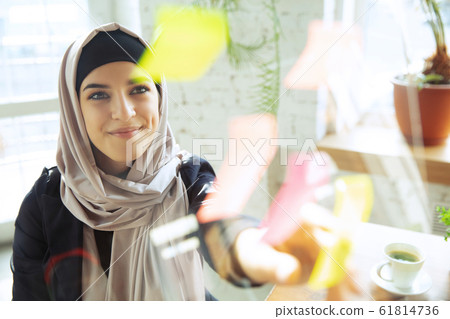 Portrait of a beautiful arabian businesswoman wearing hijab while working Portrait of a beautiful arabian businesswoman wearing hijab while working 61814736