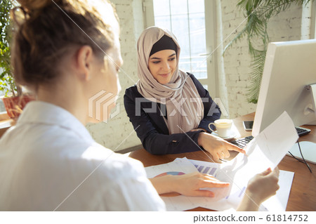 Portrait of a beautiful arabian businesswoman wearing hijab while working 61814752