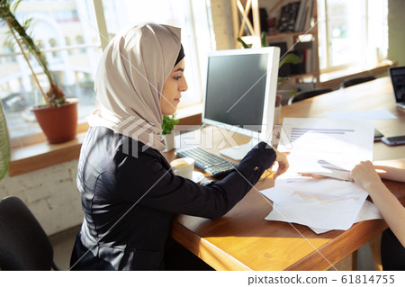 Portrait of a beautiful arabian businesswoman wearing hijab while working 61814755