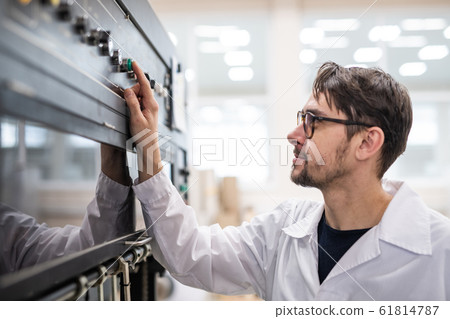 Young specialist working at factory Young specialist working at factory 61814787