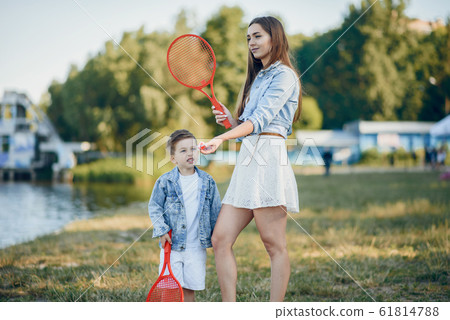 Mother with son playing in a summer park Mother with son playing in a summer park 61814788