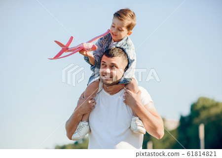 Cute family playing in a summer park Cute family playing in a summer park 61814821