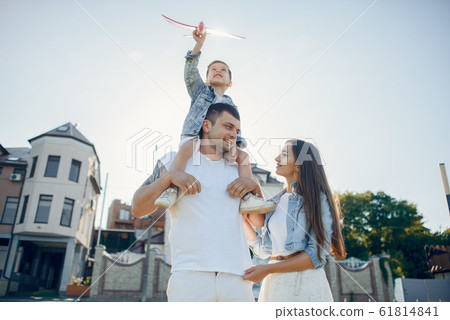 Cute family playing in a summer park Cute family playing in a summer park 61814841