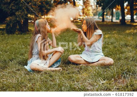 Two cute girls have fun in a summer park 61817392