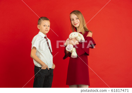 Valentine's day celebration, happy caucasian kids isolated on red background 61817471